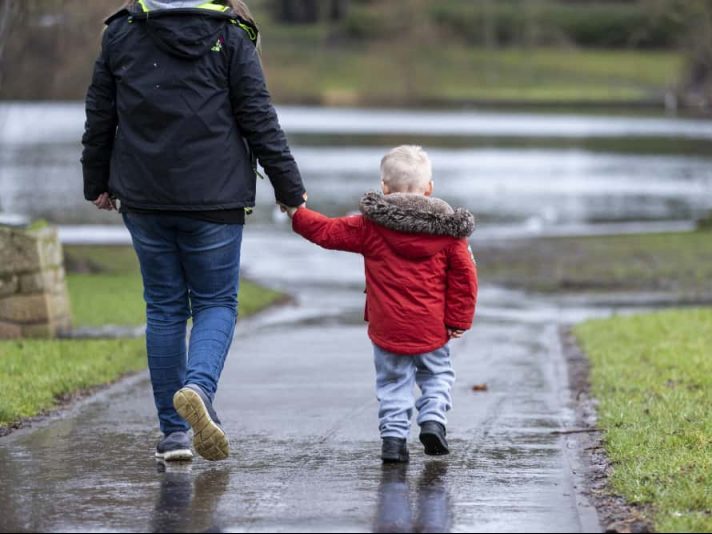 Home-Start Southern Oxfordshire case study - Emma. Woman walking with child rear view. 